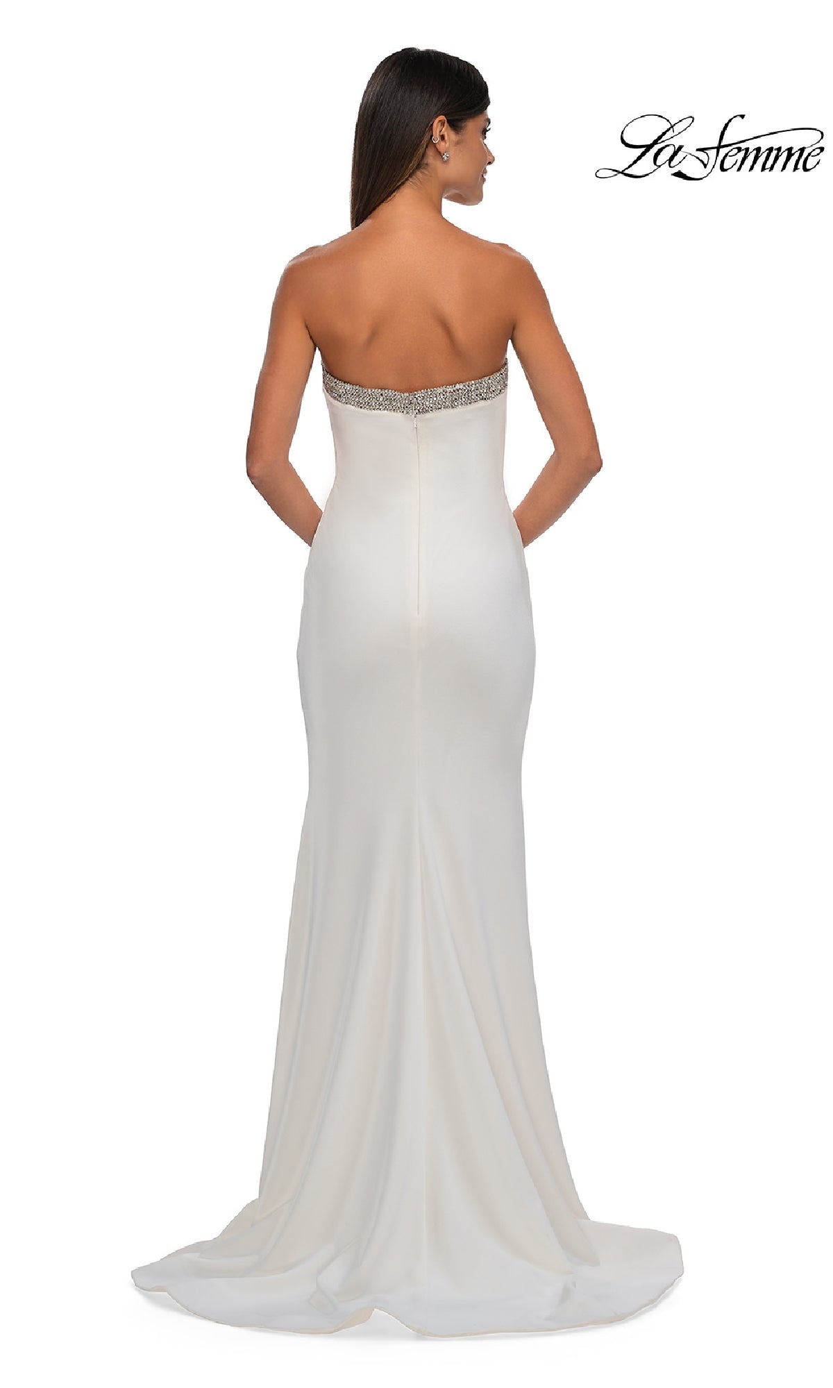 Woman in the Bead-Trimmed Long Prom Dress: La Femme 32891. This strapless, floor-length formal dress features jeweled trim at the top, a fitted silhouette, a slight train, and is shown from the back for an elegant look.